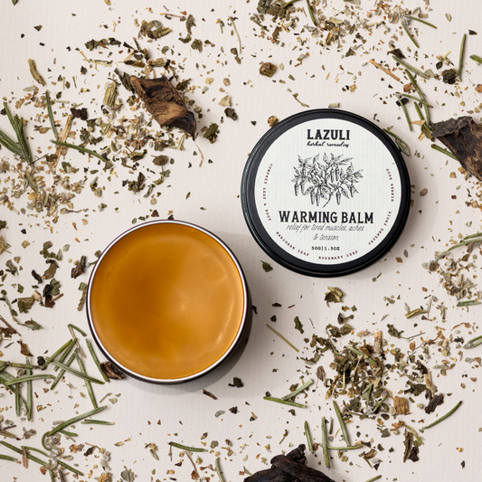 Lazuli warming balm with herbs on a white background